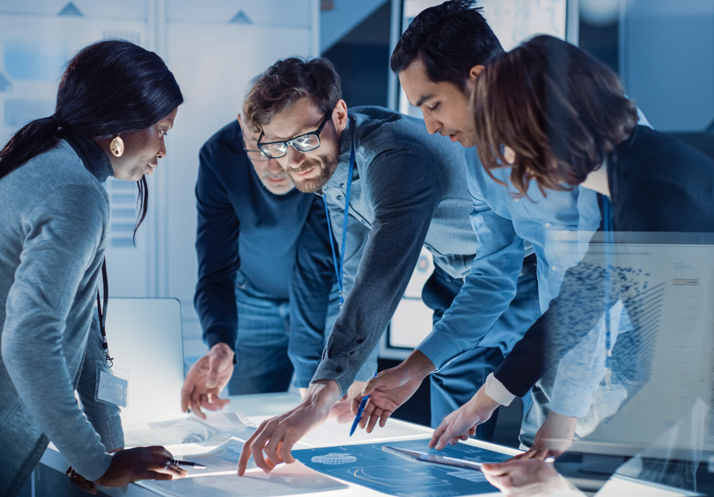 Engineers Meeting in Technology Research Laboratory: Engineers Scientists and Developers Gathered Around Illuminated Conference Table